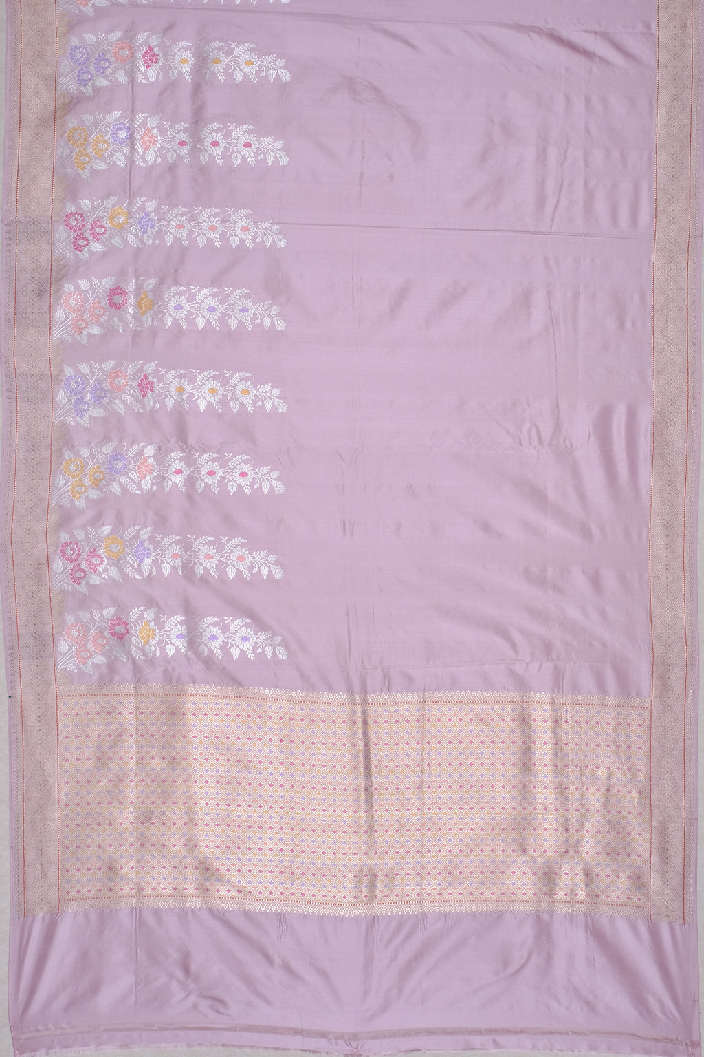 Lavender fabric with floral embroidery and a beige border